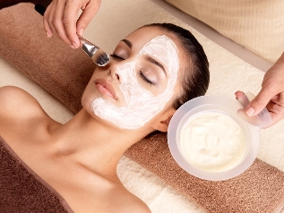 The cosmetologist applies a rejuvenating mask